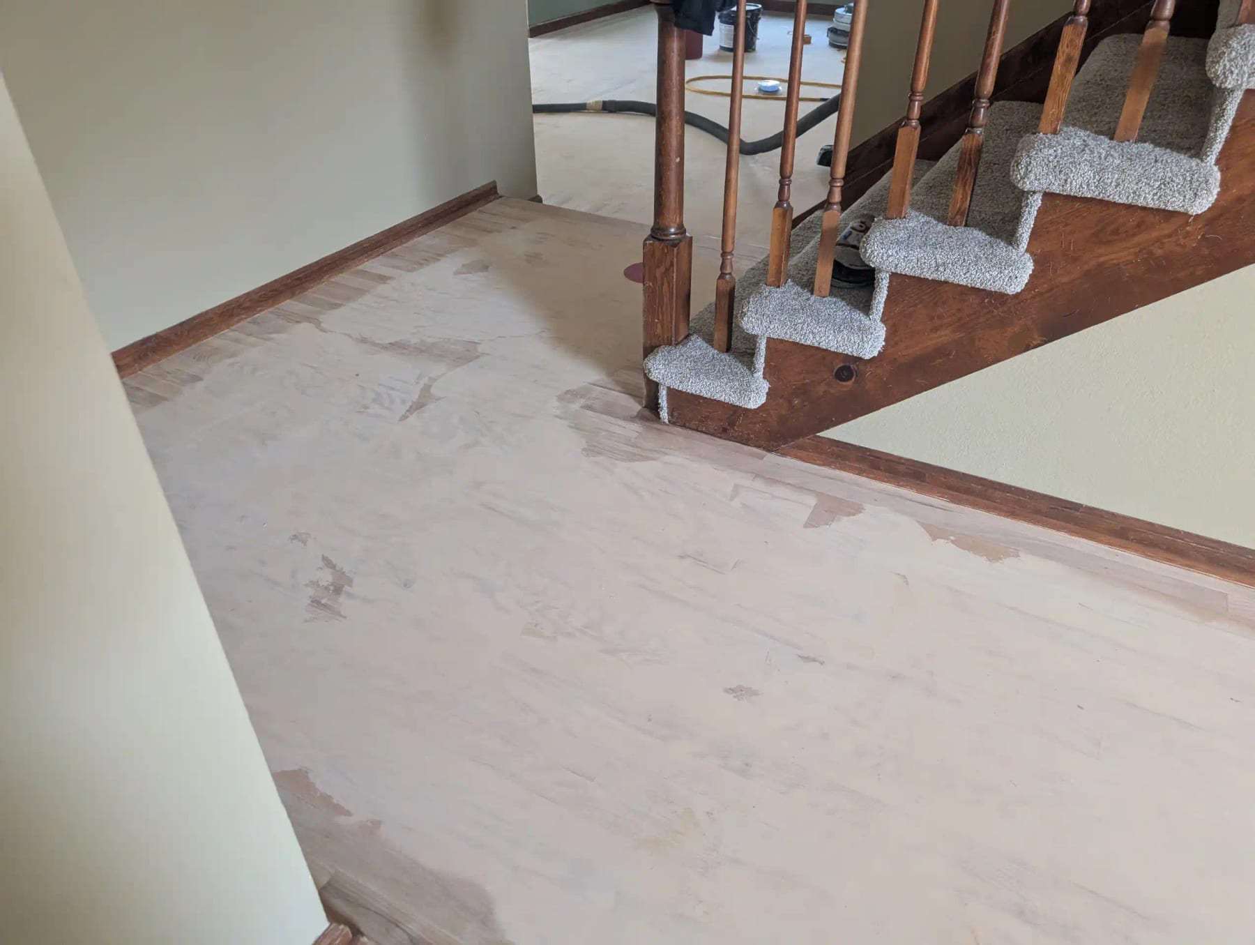 Staircase landing with the flooring removed to the subfloor