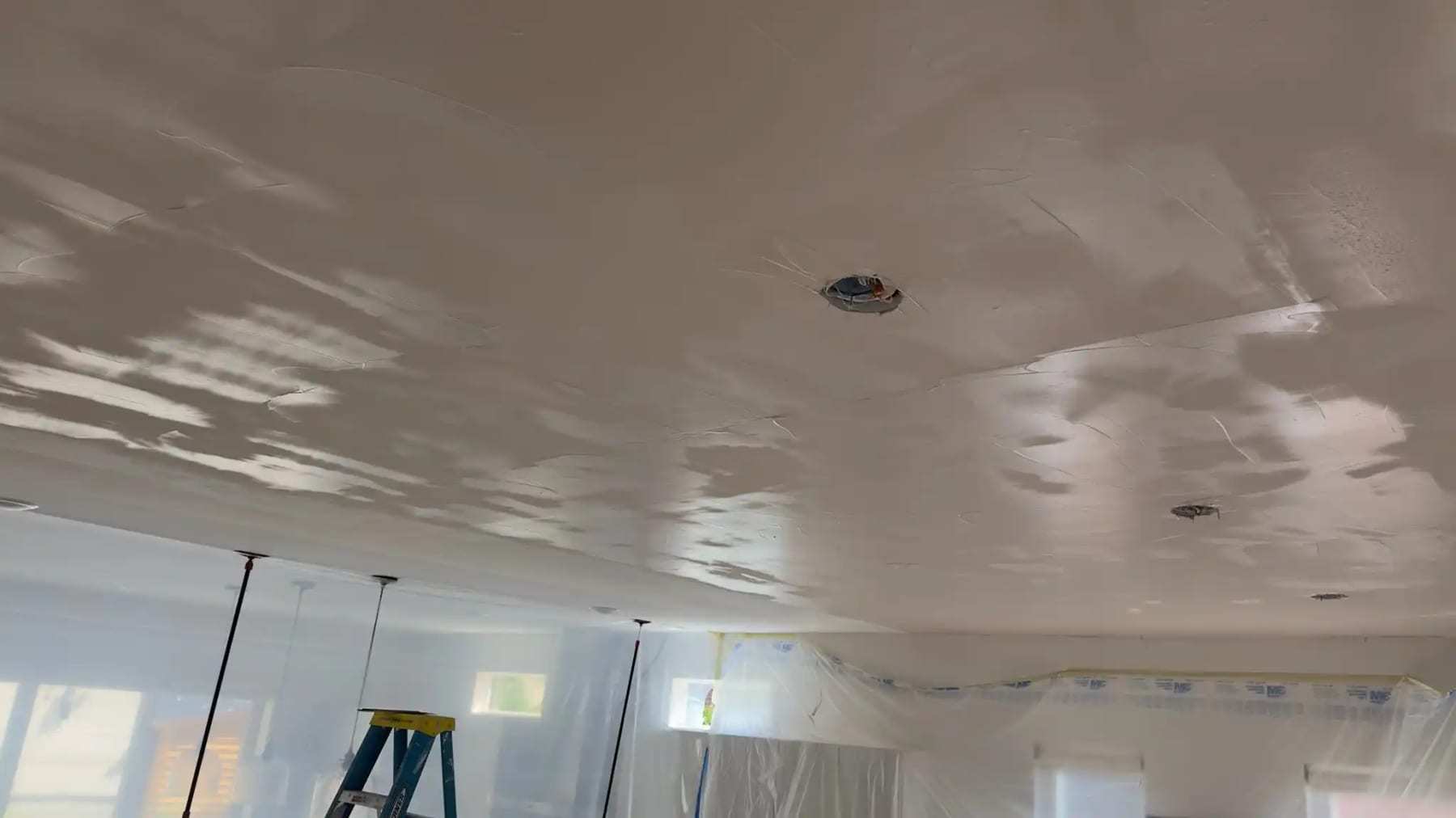 Water-stained ceiling with the texture peeling away